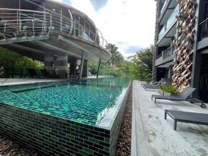 a swimming pool in the middle of a building at EMERALD TERRACE CONDO 52-FAMILY 1 Bedroom POOL VIEW in Patong Beach +13 photos