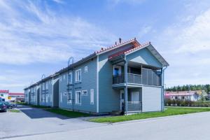 a blue building with a second story at Spacious Apartment for 8 with Sauna in Kerava