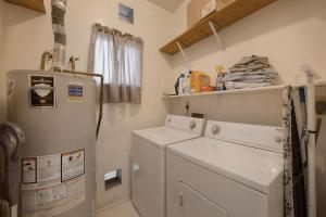 a kitchen with a refrigerator and a washer and dryer at Charming Spanish Style Vintage Casita in Tucson +31 photos