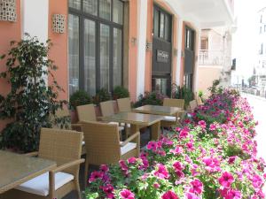 a patio of a restaurant with tables and flowers at Hotel Caporal in Minori