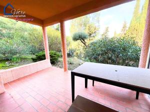 a screened in porch with a bench on a patio at L'Empereur Colliourenc in Collioure