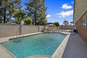 a swimming pool in the backyard of a house at Boho on Bermuda By Rather Be Properties in Tucson