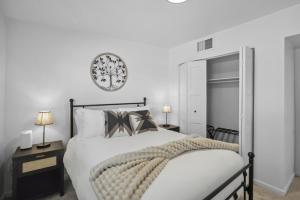 a bedroom with a bed and a clock on the wall at Boho on Bermuda By Rather Be Properties in Tucson +39 photos
