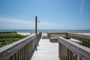 a boardwalk to the beach with the ocean in the background at Oceanfront Estate with private pool and hot tub in North Topsail Beach +79 photos