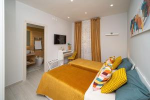 a hotel room with two beds and a bathroom at Margiò Bed and Breakfast in Fiumicino