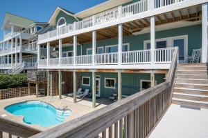 a large house with a swimming pool and a balcony at Oceanfront Estate with private pool and hot tub in North Topsail Beach