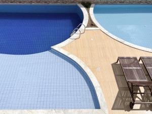 two swimming pools with two chairs next to each other at 2Qts, 6km do Parque do Povo in Campina Grande