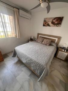 a bedroom with a bed and a ceiling fan at LAGUNA BEACH PISCINA- HOME RENt MALAGA in Torrox Costa +24 photos