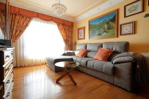 a living room with a couch and a table at Apartamento As Carolinas in Vilagarcia de Arousa