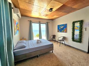 a bedroom with a bed and a large window at Hotel Horizonte Azul in Casares