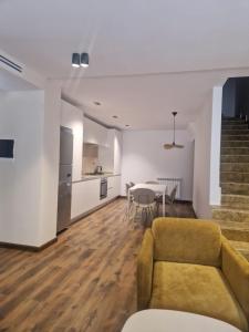 a living room with a couch and a table at Duplex trouville à 2 pas de la plage in Aïn El Turk