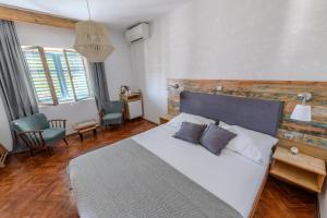 a bedroom with a large bed with a wooden headboard at Guest house Mediterranea in Pakoštane