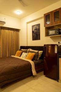 a bedroom with a bed and a couch at The Nest Studio by Raaya Nook in Jaipur