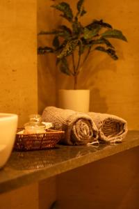 a towel and a basket on a counter with a plant at The Nest Studio by Raaya Nook in Jaipur