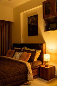 a bedroom with a bed and a table with a lamp at The Nest Studio by Raaya Nook in Jaipur