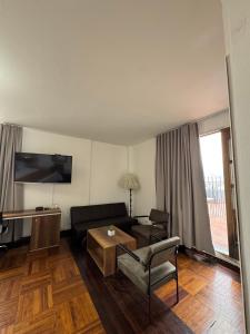 a living room with a couch and a table at Hotel Nutibara in Medellín
