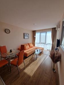 a living room with a couch and a table at Premier Fort Beach Apartment with Pool & Sea View in Sveti Vlas