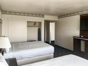 a hotel room with two beds and a television at Oceanside, CA – Marina / Camp Pendleton in Oceanside