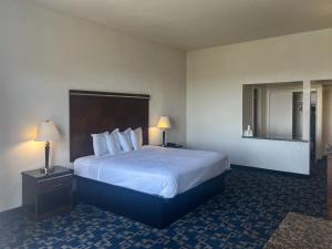 a hotel room with a large bed and two lamps at Oceanside, CA – Marina / Camp Pendleton in Oceanside