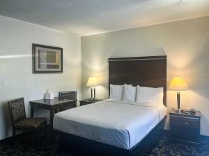 a hotel room with a large bed and a chair at Oceanside, CA – Marina / Camp Pendleton in Oceanside
