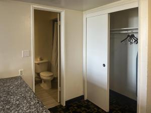 a bathroom with a toilet and a glass door at Oceanside, CA – Marina / Camp Pendleton in Oceanside