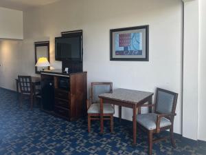 a hotel room with a table and chairs and a television at Oceanside, CA – Marina / Camp Pendleton in Oceanside