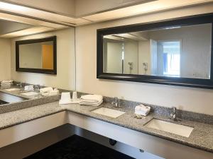 a bathroom with two sinks and a large mirror at Oceanside, CA – Marina / Camp Pendleton in Oceanside