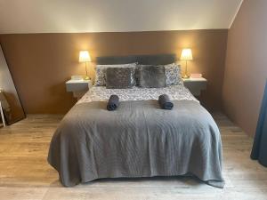 a bedroom with a large bed with two night stands at Wind Rose Rooms in Ballycastle +9 photos