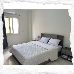 a bedroom with a large bed with white sheets and a window at 北京之夜华人民宿餐厅 chinese hotel in Banī Ghālib +7 photos