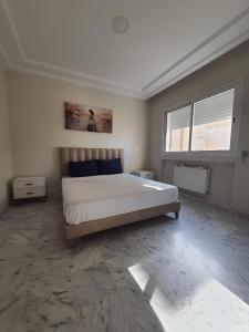 a bedroom with a bed and a window in it at Jinene in Sidi Daoud