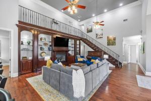 a living room with a large couch and a staircase at Downtown Estate Luxury Property in Hammond