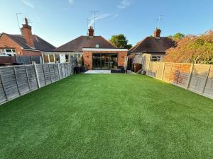 a large yard with green grass in front of a house at Simple Luxury 2Bed Cosy Bungalow in Dallington