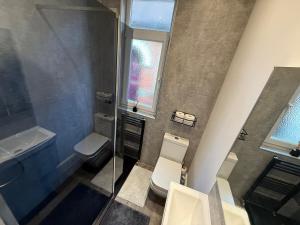 a bathroom with a toilet and a sink and a window at Simple Luxury 2Bed Cosy Bungalow in Dallington +74 photos