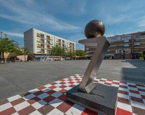 a statue of a ball on a checkered floor at Studio apartman Trg in Županja
