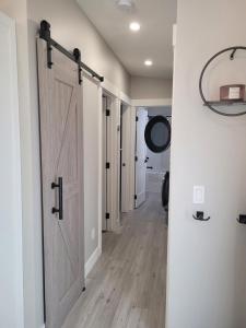 a hallway with a sliding barn door in a house at Creekside Oasis on Mara in Sicamous +21 photos