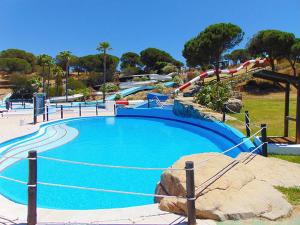 a water park with a blue pool and slides at Relax Pinares in Lepe