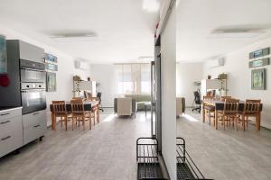 a kitchen and dining room with a table and chairs at Bandiland Szigetmonostor Horány in Szigetmonostor