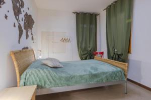 a bedroom with a bed and green curtains at Art & Culture Biennale - Venezia Sweet Stay in Venice