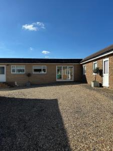 a house with a gravel driveway in front of it at Kittsmead in Cowden