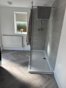 a shower with a glass door in a bathroom at Kittsmead in Cowden +29 photos