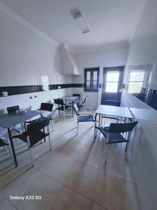 a room with tables and chairs in a building at HOSTEL MISTO-Low Cost Palmela in Palmela +6 photos