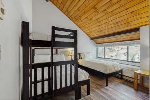 a bedroom with two bunk beds and a window at Loon Mountain Nest in Lincoln +47 photos
