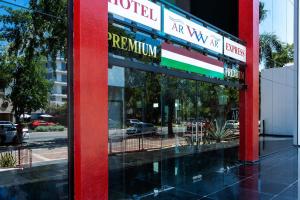 a red sign for a restaurant on a city street at Hotel WW in Mérida
