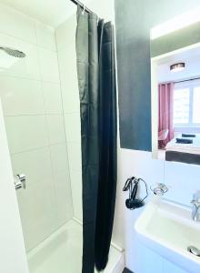 a bathroom with a tub and a sink and a shower at Central city apartment in Zurich! in Zürich