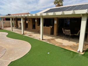a building with a patio with a putting green at Mesquite paradise in Mesquite