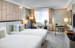 A bed or beds in a room at Kempinski Hotel Corvinus Budapest