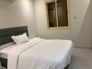 a white bed in a room with a window at رومانوس فيلاجيو ROMANOS Villagio in Obhor +15 photos