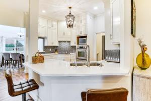 a kitchen with white cabinets and a large island at Spacious Family Retreat in Fort Worth Area! in Aledo