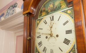 a grandfather clock is sitting next to a wall at Shoreline Accommodation in Bournemouth