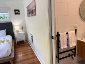 a small bedroom with a bed and a sink at Beach Holiday Home-Close to Airport-3 Bed & 2 Bath in Lauderdale